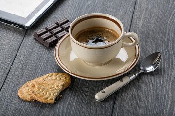 A cup of coffee and biscuits