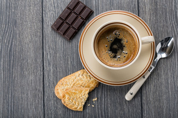 A cup of coffee and biscuits