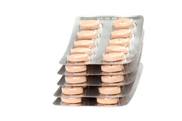 Pills in blister packs on white background.