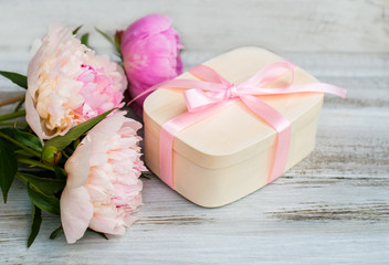  Flowers and a box with a gift on a turquoise background. The concept of a holiday