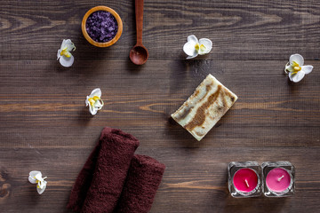 Fototapeta na wymiar Candles and soap for aroma relax bath on wooden table background top view