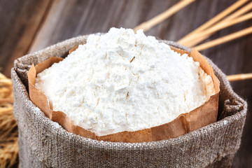 Flour in a canvas bag, wheat ears.