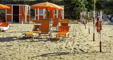 Orange umbrellas and chaise lounges on the beach of Vieste in Italy - the destination in the Adriatic coast apulia