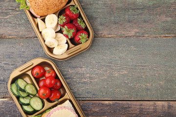 School lunch in boxes on wooden table