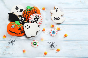 Fresh halloween gingerbread cookies on white wooden table