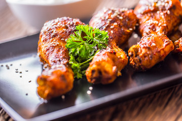 Grill chicken legs. Grilled chicken legs BBQ with sesame parsley and tomato.