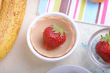 Close-up detail of a fresh red strawberry with leaves