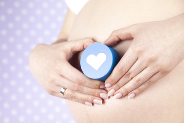 Pregnant woman holding a heart
