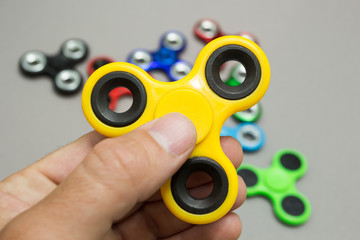 Hand holding popular fidget spinner toy