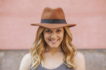 portrait of a young cheerful woman wearing a hat