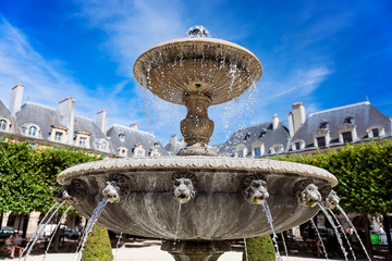 Fountain in the Place des Vosges (Place Royale) - the oldest squere in Paris located in Le Marais district.