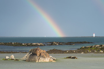 Rainbow over the sea seen from a beach