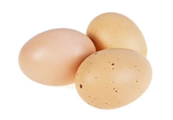 Three chicken eggs isolated on a white background