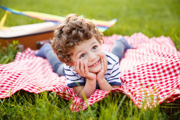 Boy lying on blanket outdoors