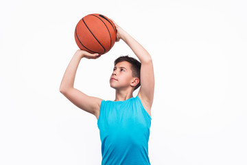 Young boy playing basketball isolated on white