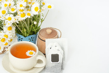 cup of herbal chamomile tea with fresh daisy flowers. doctor treatment and prevention of immune concept, medicine - folk, alternative, complementary, traditional medicine 