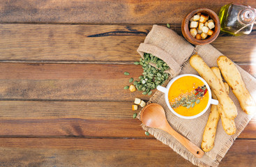 Sweet potato carrot soup on a wood background.