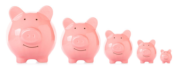 Piggy banks of different sizes on white background