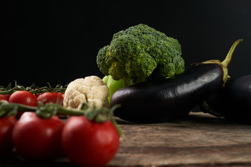 Close-up of Fresh raw vegetable ingredients for healthy cooking or salad. Dark background, copy space. Diet , vegetarian or vegan food.