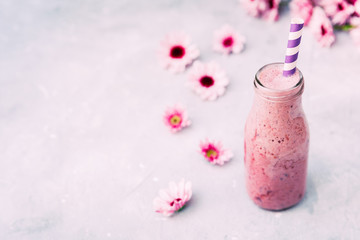 Detox cleanse drink concept with flowers over vintage background