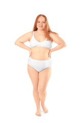 Fototapeta premium Overweight young woman in underwear isolated on white. Diet concept