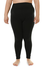 Overweight woman in black leggings on white background. Diet concept