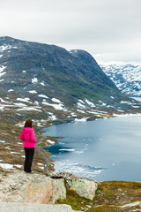 Fototapeta na wymiar Tourist woman standing by Djupvatnet lake, Norway