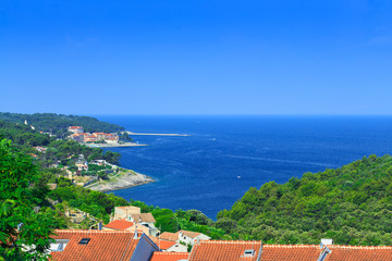 Traditional european Mediterranean architectural style, streets & houses with terracotta roofs, surrounded by cypress, palm, olive, pine trees, on coast azure sea. Location of the prestigious estates