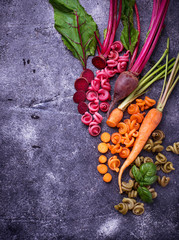 Colorful pasta with carrot, beetroot and basil