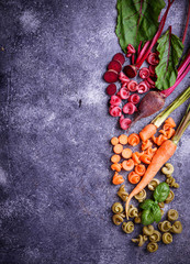 Colorful pasta with carrot, beetroot and basil