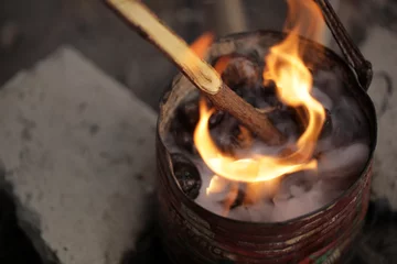 Fotobehang fire and smoke - roasting cashew nuts © agarianna