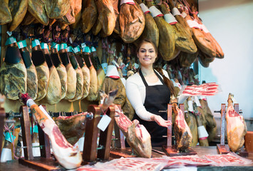 Happy woman offering tasty jamon