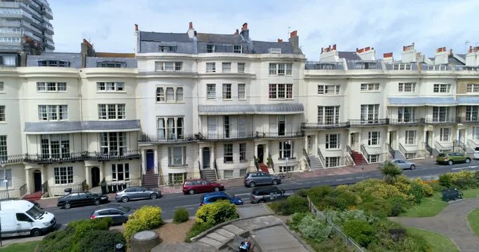 Aerial ascending view of the town of Brighton and Hove looking West into a regency square