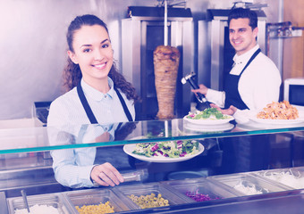 Fototapeta na wymiar Positive employees working with kebab