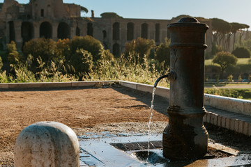 Naklejka premium Old drinking water fountain in Rome, Italy