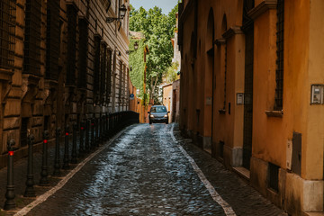 Narrow street in Rome, Italy at summer