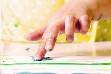little girl learning to paint (child development in art)