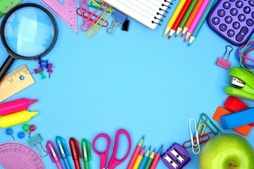School supplies frame against a blue paper background