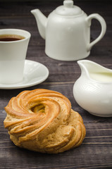 pastries, creamer, cup of coffee and teapot/pastries, creamer, cup of coffee and teapot on a table