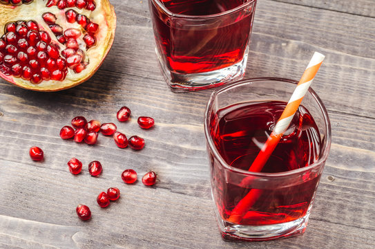 two glasses with juice and pomegranate fruit. Top view/Two glasses with juice and pomegranate fruit