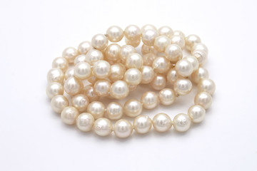 Closeup Pile of Pearls on White Background