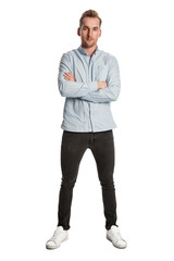 Fototapeta premium Good looking blonde man wearing a light blue shirt standing against a white background looking at camera.