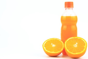 Orange juice in plastic bottle on white background with orange fruit