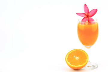 Orange juice in glass on white background and flowers with orange fruit