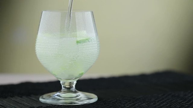 Refreshing drink, lime in a glass with sparkling water. Footage, HD 1080i
