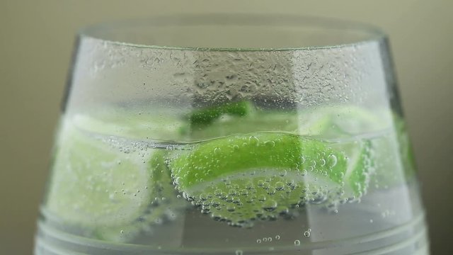 Refreshing drink, lime in a glass with sparkling water. Footage, HD 1080i
