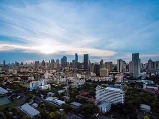 Fototapeta premium aerial view modern building business in city and big blue cloudy sky with transportation both road and river at sunset background