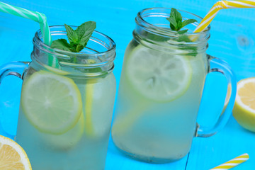 Fresh citrus lemonade in mason jars on table