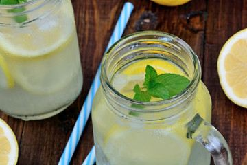 Cold fresh citrus lemonade in mason jars on table