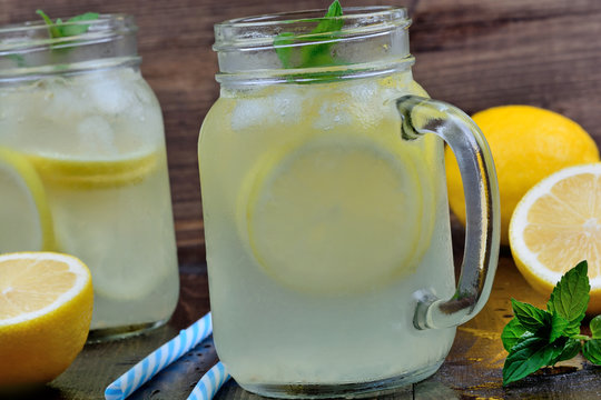 Lemonade with mint in mason jars on table